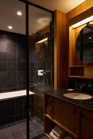 Room includes basin, bathtub, mirror
