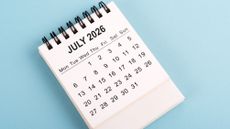 A July 2026 calendar against a blue background