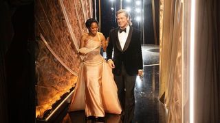 Brad Pitt and Regina King backstage at the Oscars.