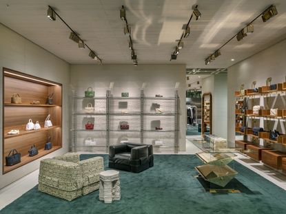 Bottega Veneta fashion store interior with leather chairs and shelves with handbags