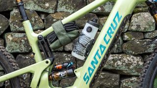 Peaty's Holdfast Tool Wrap and water bottle attached to bike frame