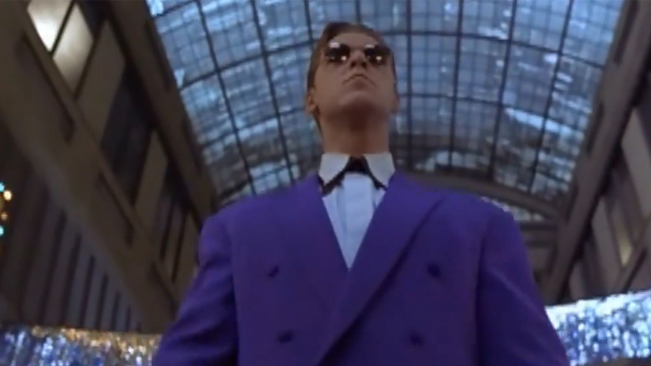 Russell Crown in a purple suit and sunglasses in Virtuosity.