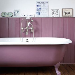 bathroom with wooden flooring and purple coloured bathtub