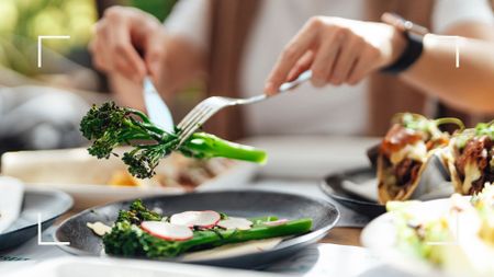 The best foods to eat in a heatwave - woman picking up sprig of broccoli