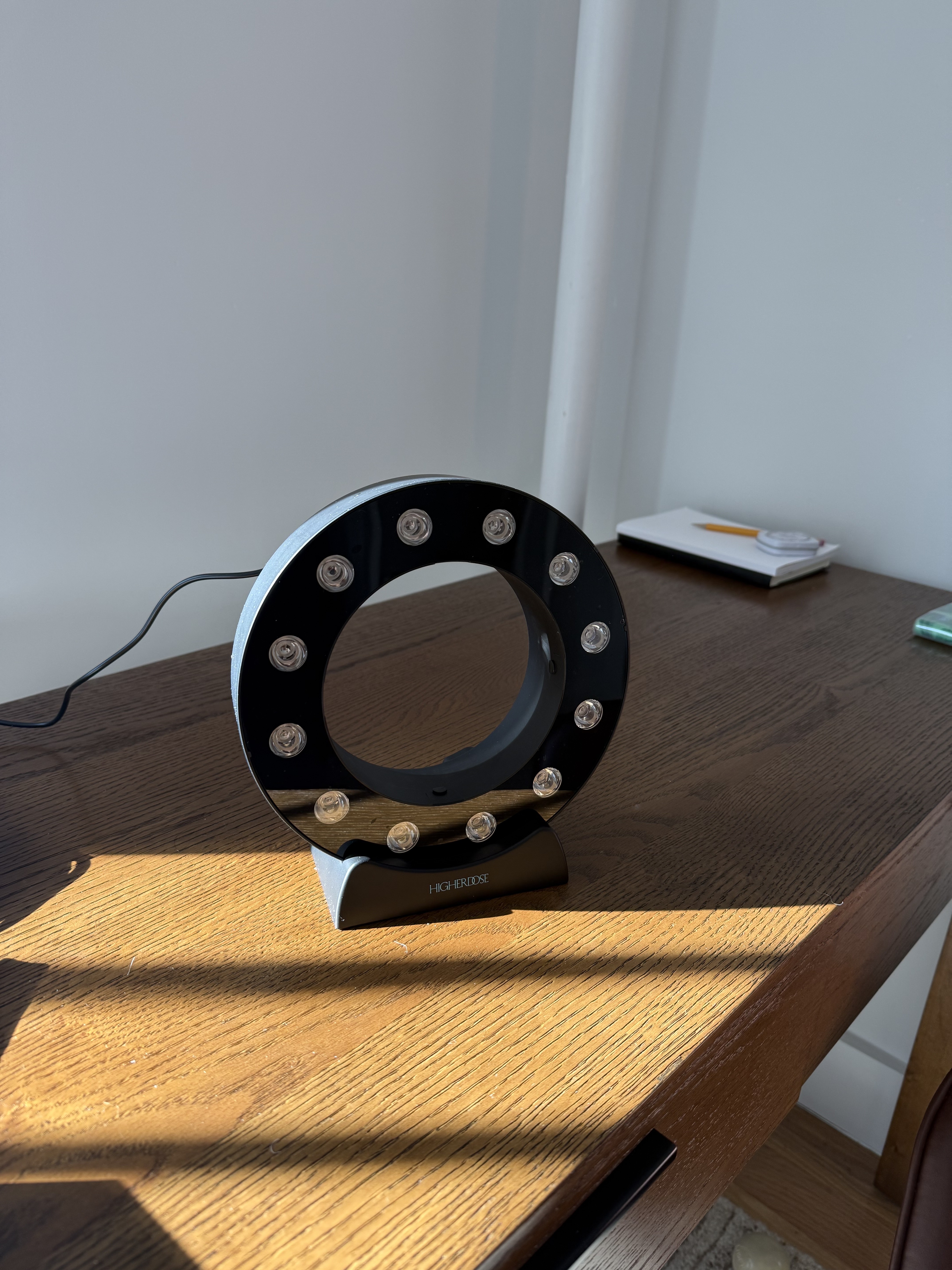 Photo of Jamie Schneider testing HigherDose's new Red Light Showerhead Filter