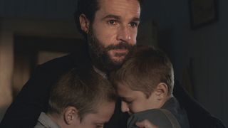 Christopher Abbott as Adam Trask hugging his young sons in East of Eden