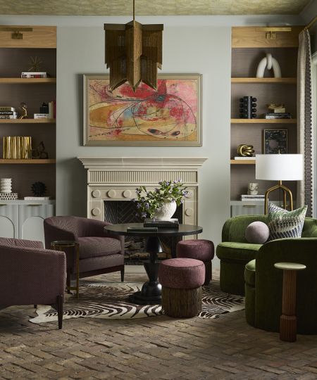 living room with pale blue walls and green and purple armchairs and brick flooring