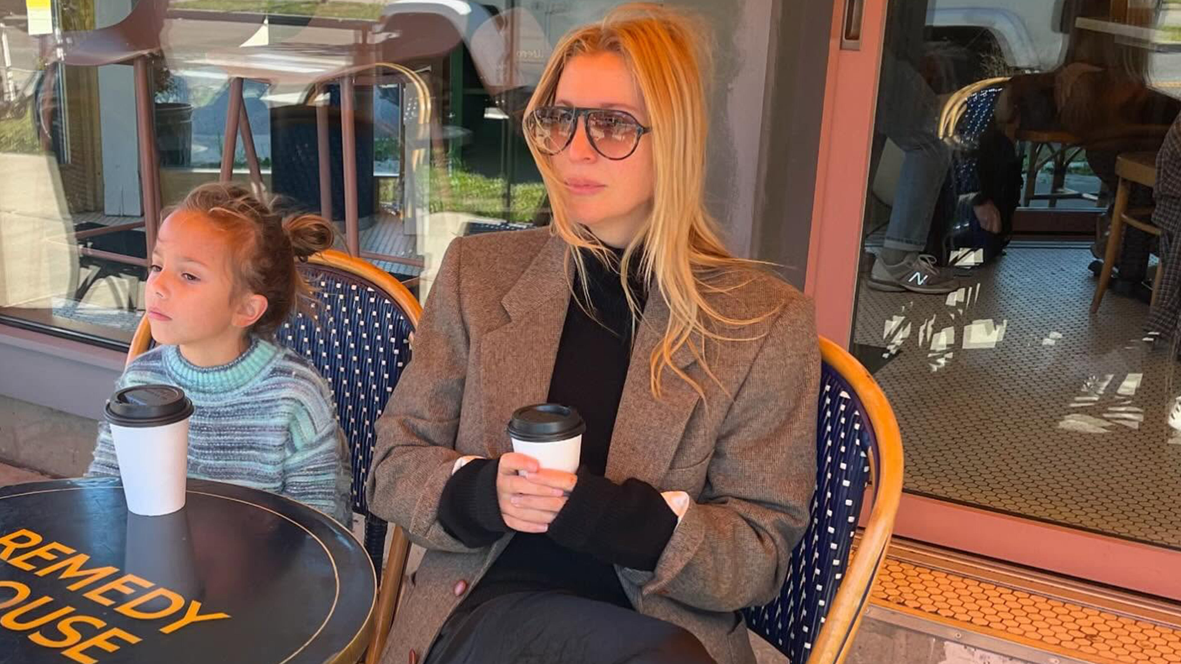 Kerry Pieri sitting outside at a cafe with her daughter.