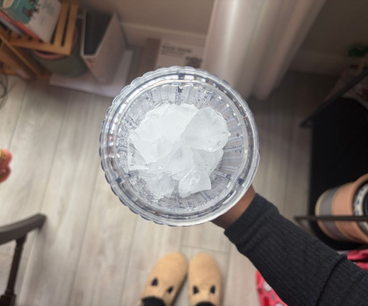 Chunks of ice inside a small clear pitcher blender
