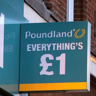 a Poundland sign hanging from a wall outside the shop