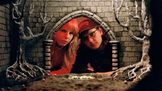 Earth Tongue looking through the entrance of a toy castle
