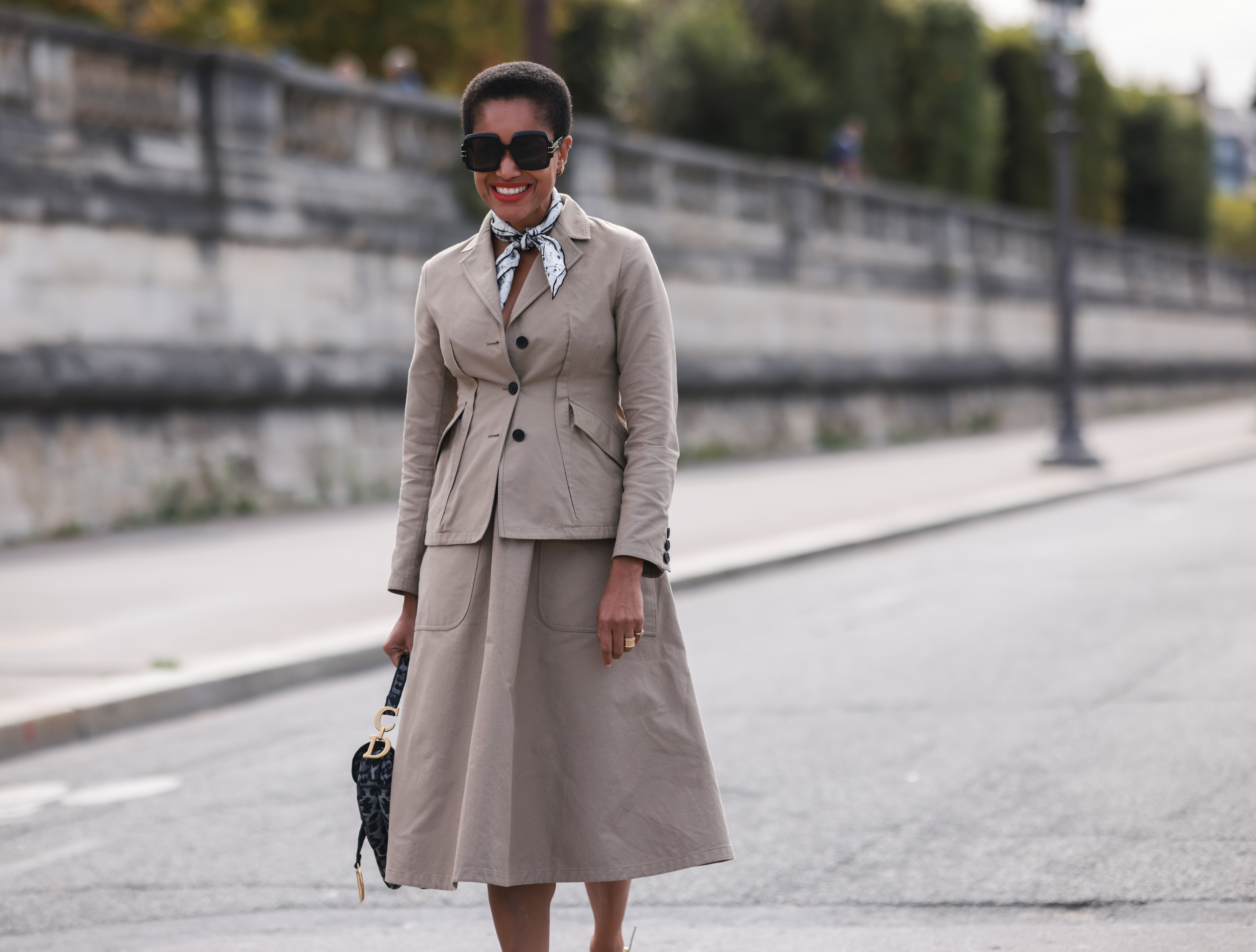 Tamu McPherson wearing a beige blazer and skirt, a black dior bag on September 28, 2021 in Paris, France.