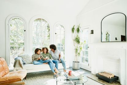 mother and daughters sitting in living room