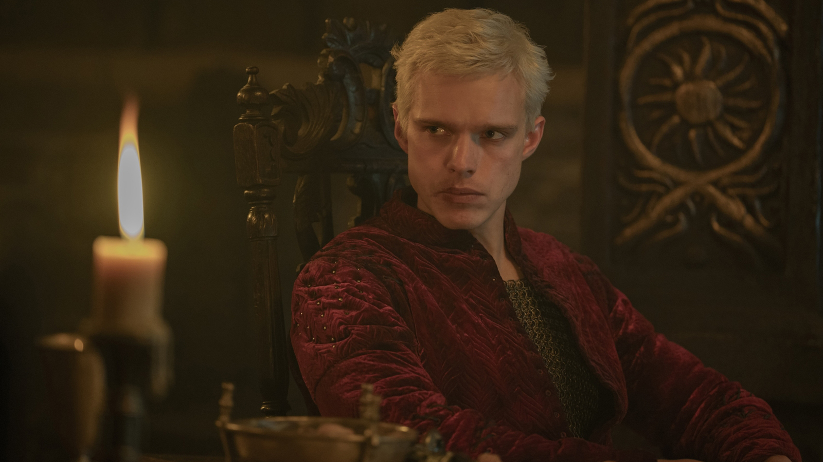 Aerion Targaryen sitting down next to a lit candle in A Knight of the Seven Kingdoms episode 4