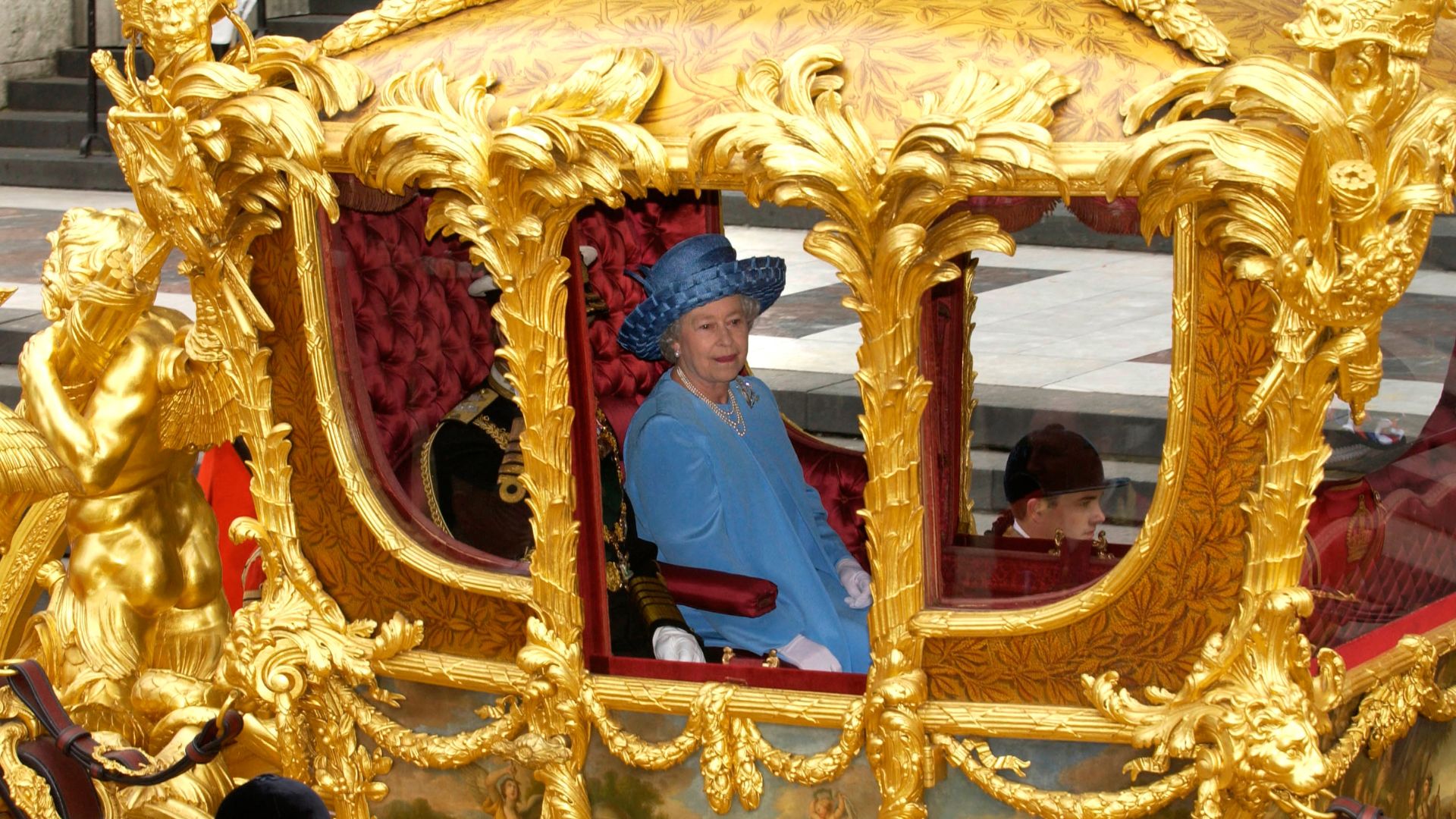 Queen Elizabeth II riding in the Gold State Coach
