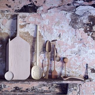 unfinished plaster wall with wooden spoons