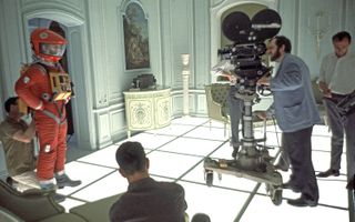 Stanley Kubrick on the set of "2001" at the MGM British Studios in Borehamwood, Hertfordshire, 1966. On the left is American actor Keir Dullea in a spacesuit.