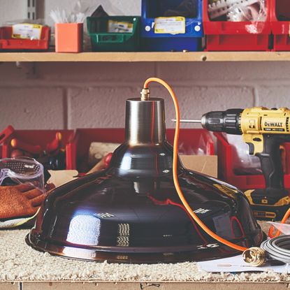 An at-home DIY station with colourful containers and a yellow DeWalt drill