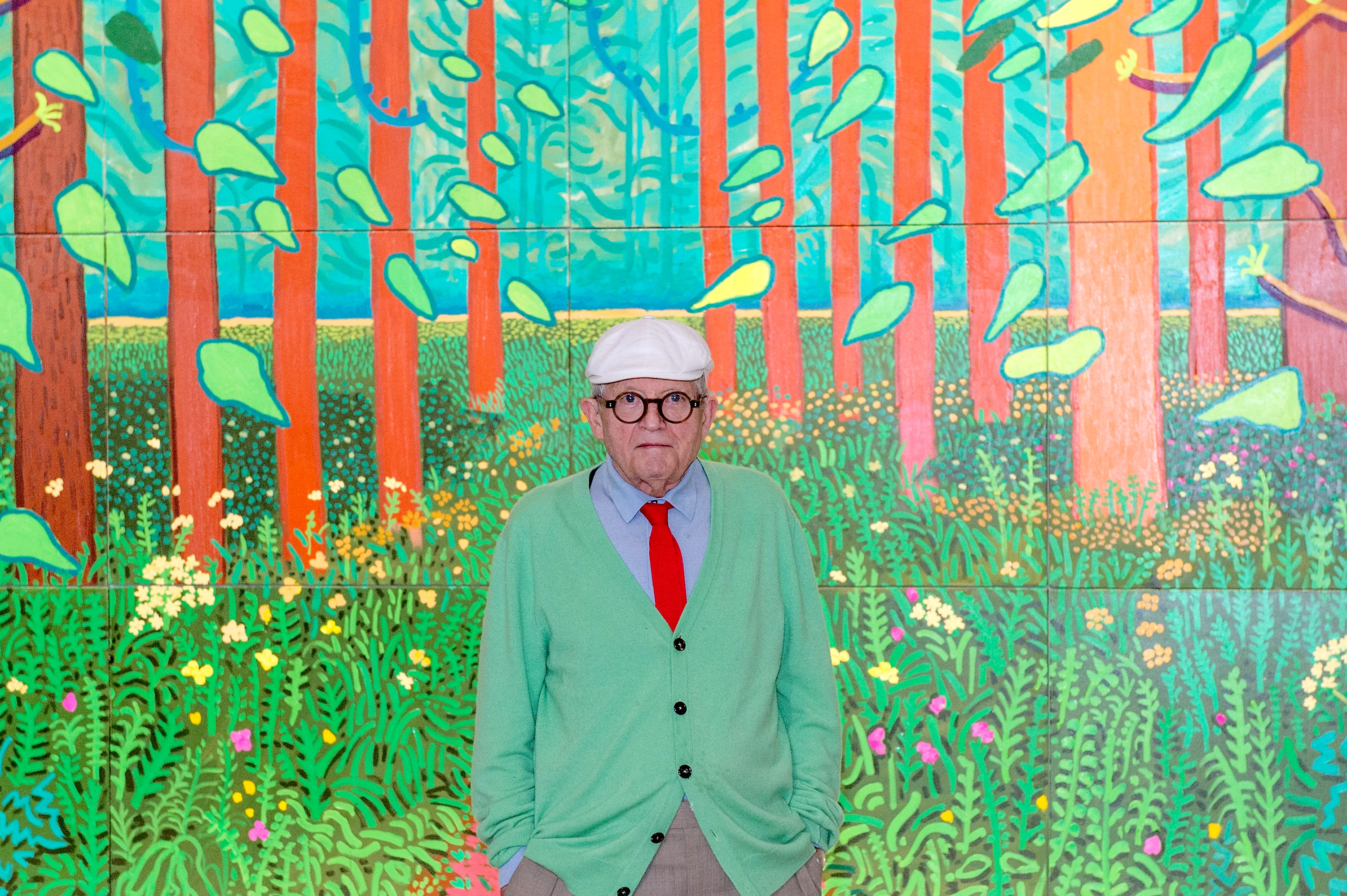 David Hockney in front of the painting 'The Arrival of Spring in Woldgate, East Yorkshire in 2011'