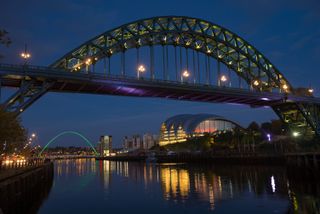 Cityscapes at night are best shot with exposures lasting seconds, with a narrow aperture, and a low ISO.