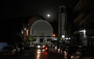 The full moon over the Orthodox Church of 12 Apostoles in Artaki, on Euboea, Greece, on March 31, 2018. 