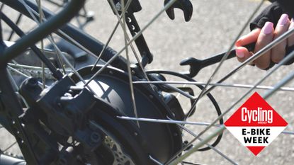 Female cyclist maintaining an electric bike