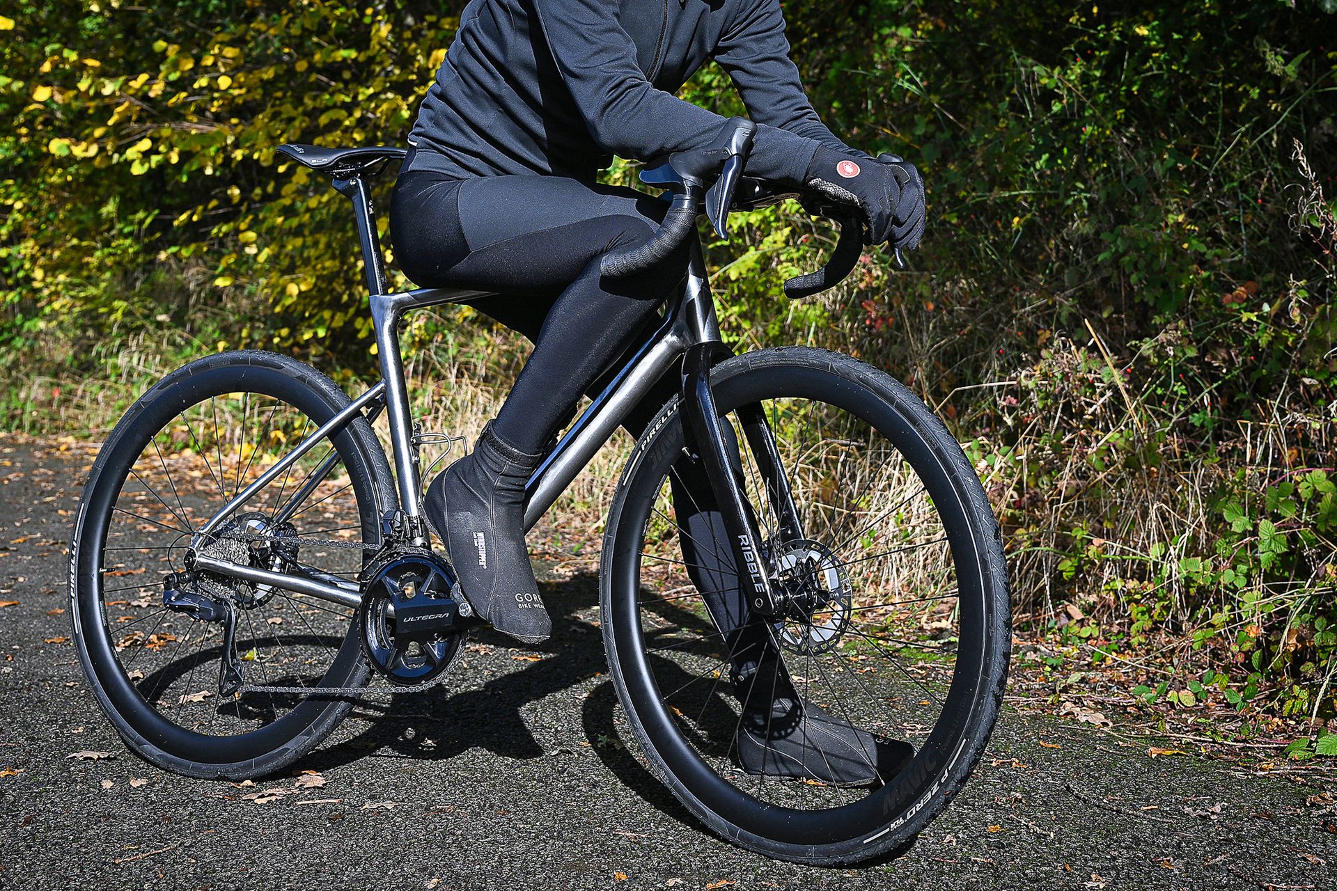 Male cyclist sitting on the top tube of the Ribble Allroad Ti Pro