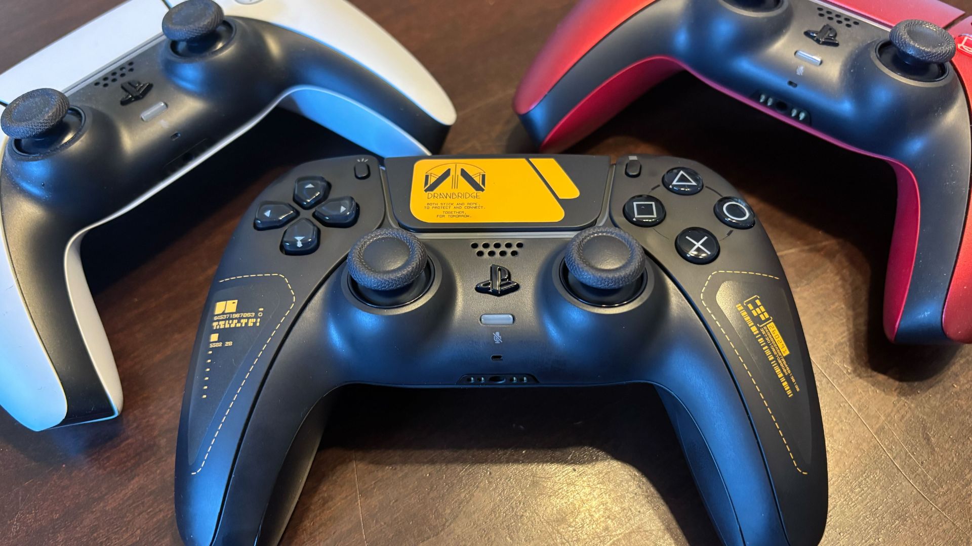 The Death Stranding 2 Limited Edition DualSense controller next to the white and red versions
