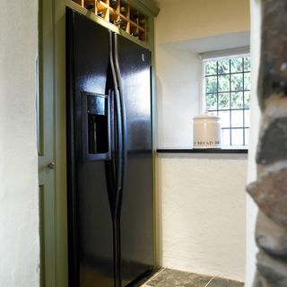 Smart refrigerator with white wall and bottles