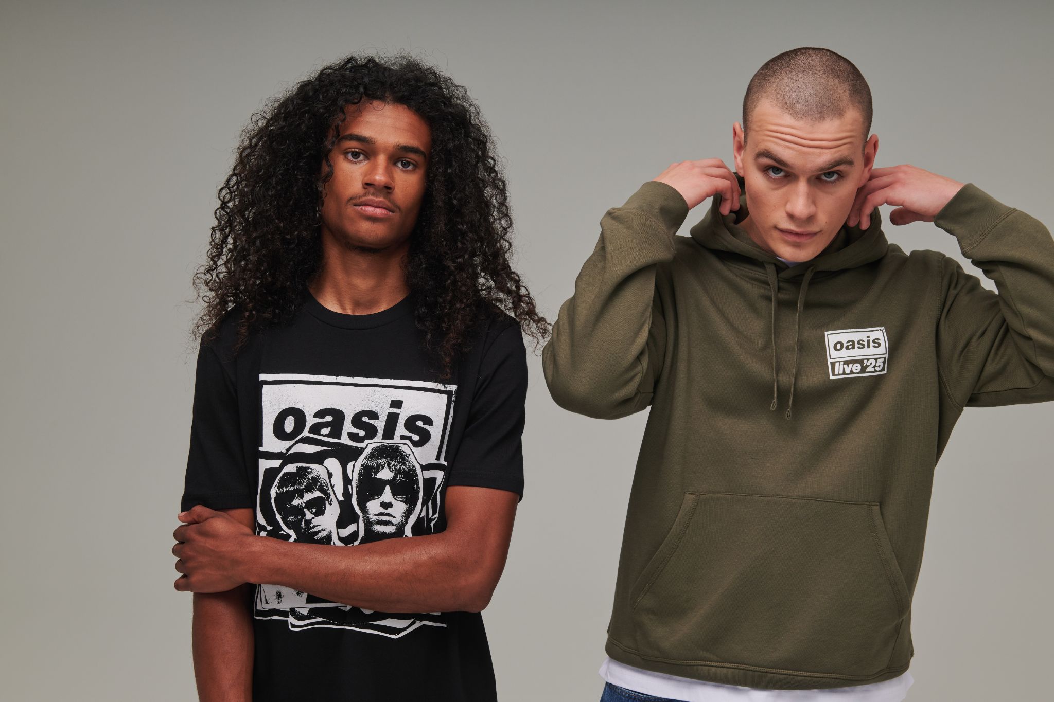 Models wearing Oasis 2025 tour merchandise