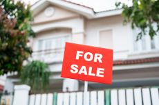 For Sale sign in front of a home.