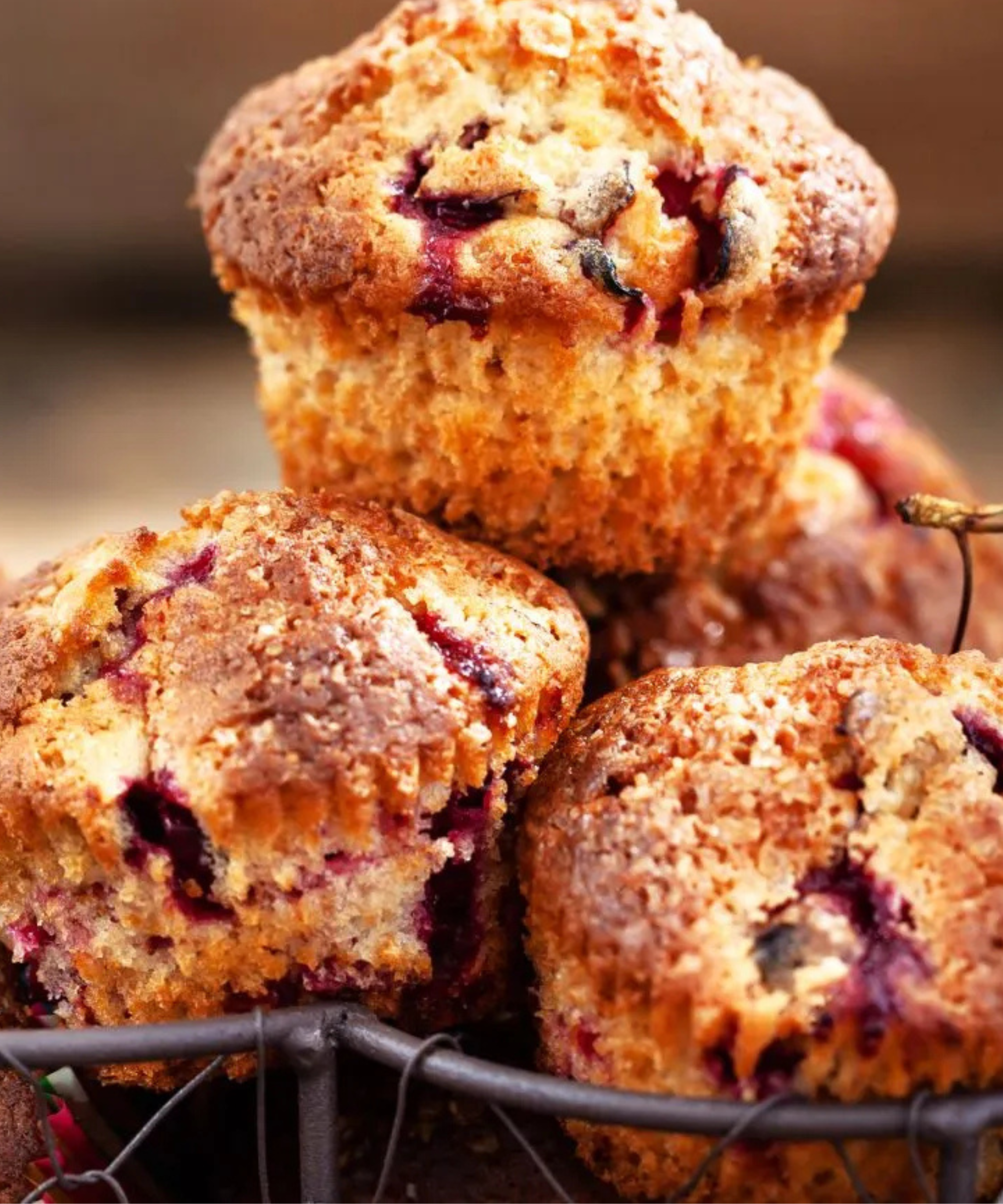Cherry muffins in a basket with check napkin and fresh cherries