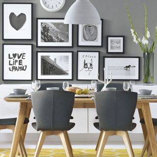 grey modern dining room with black and white pictures