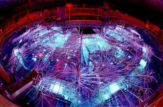 electrical arcs form a spider-web like shape inside a large bowl-shaped laboratory mechanism