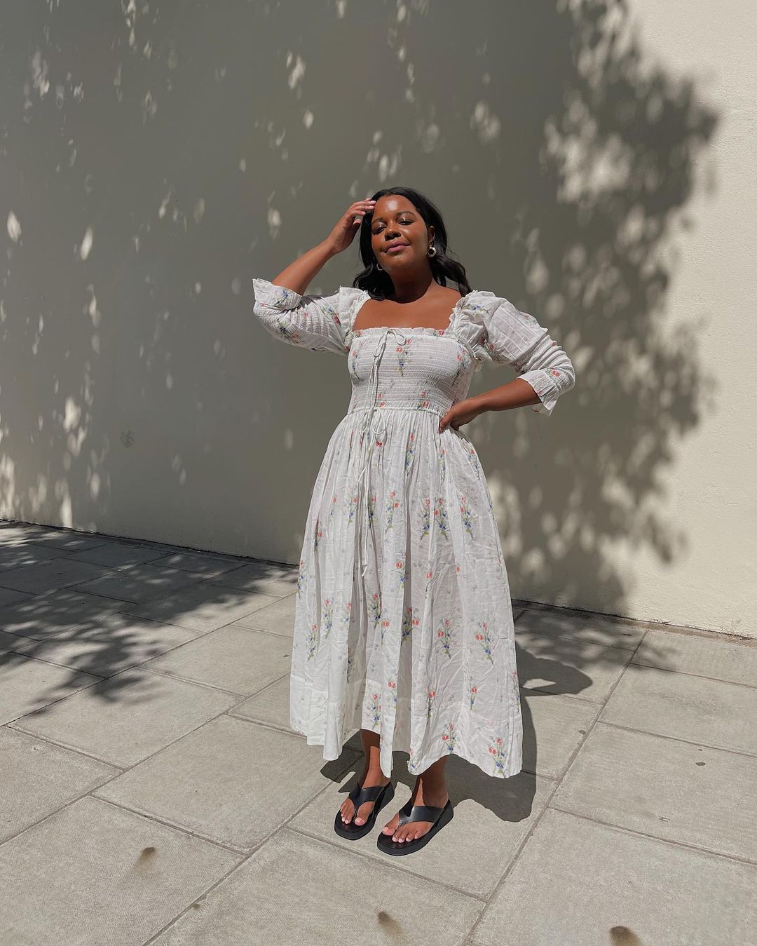 @STYLEIDEALIST wears a floral midi dress and sandals
