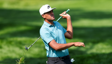 Tony Finau strikes a wedge shot