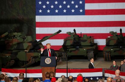 President Trump is flanked by tanks.
