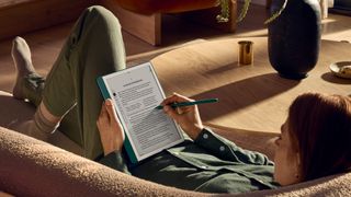 A person writes on an e-book using the Amazon Kindle Scribe