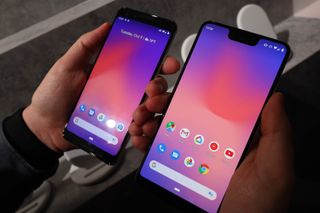 A Google Pixel 3 and Pixel 3 XL from the front in someone's hands