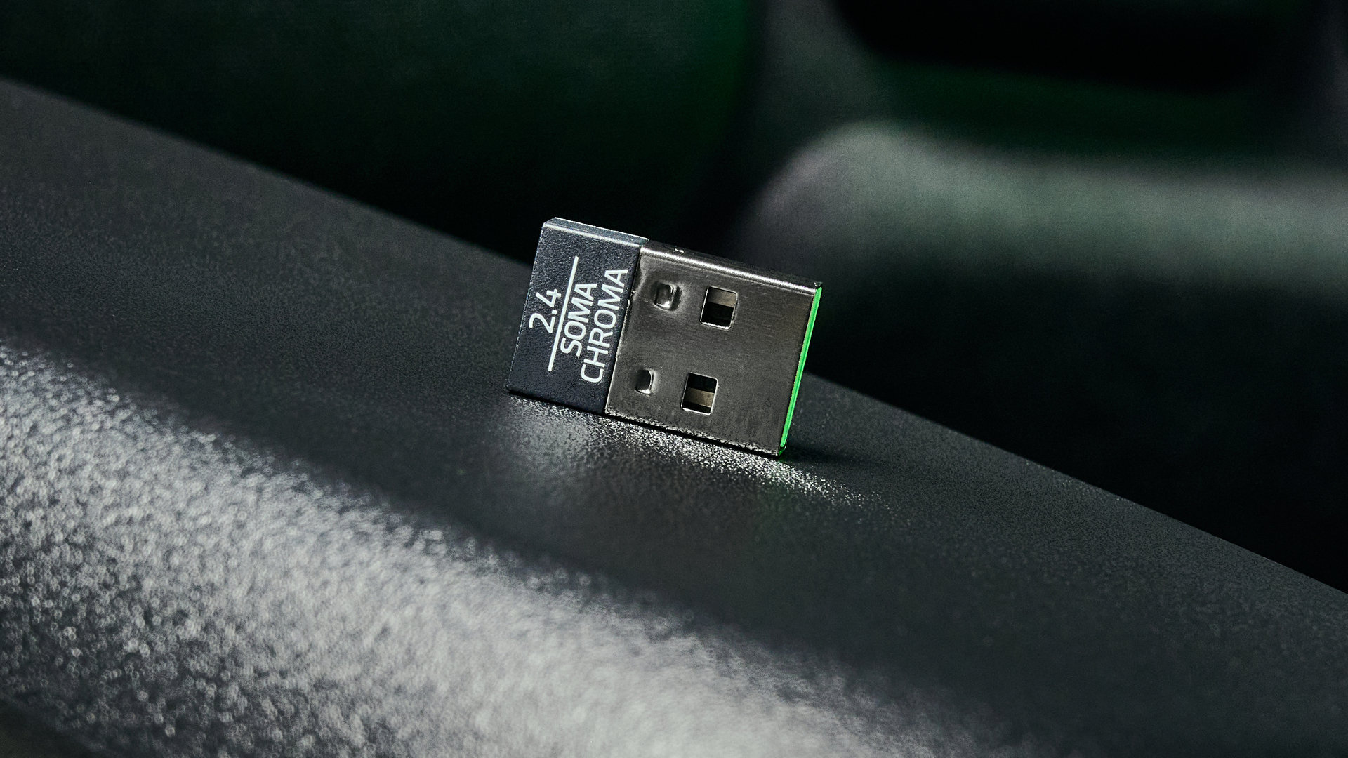 The Razer Soma Chroma chair's 2.4G dongle, sitting on its side on the chair's arm rest.