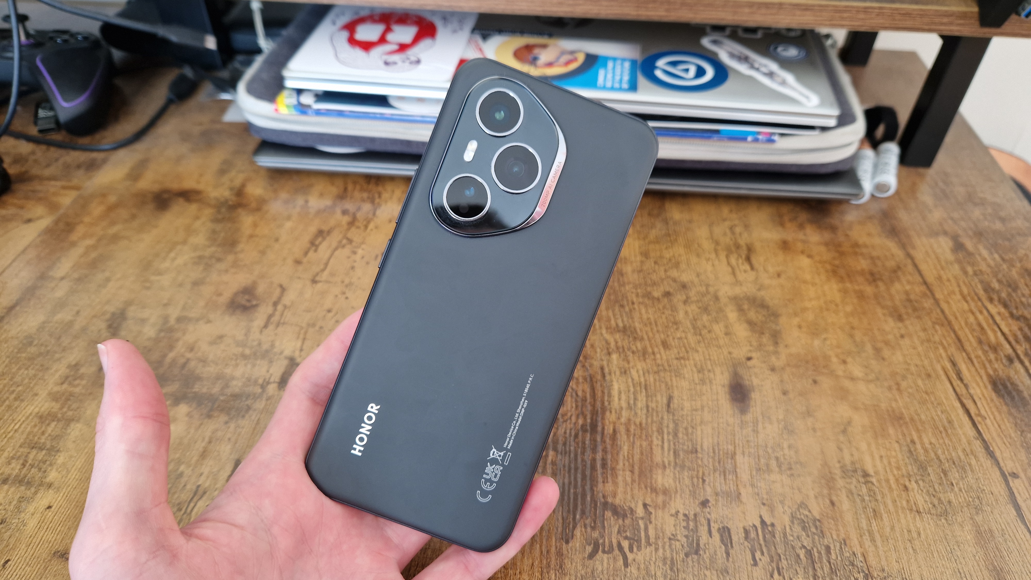 A reviewer holding the Honor 400 Pro