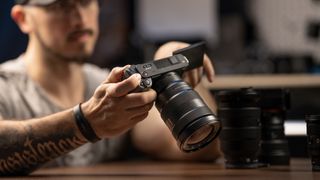 Sony ZV-E1 camera in the hands of a tatooed filmmaker lifestyle image