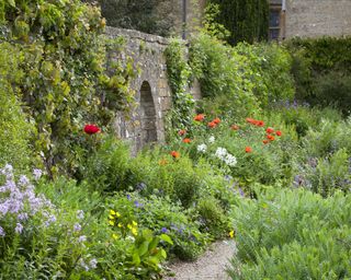 planting in the long border at National Trust Snowshill Manor arts and crafts garden