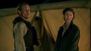 Claire and Jamie outside a military tent in Outlander season 7 episode 8