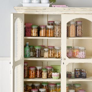 white storage unit and glass jars with food