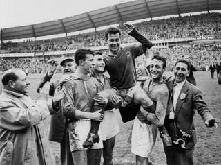 Just Fontaine is held aloft by his France team-mates after scoring four goals against West Germany in the third-place match at the 1958 World Cup.