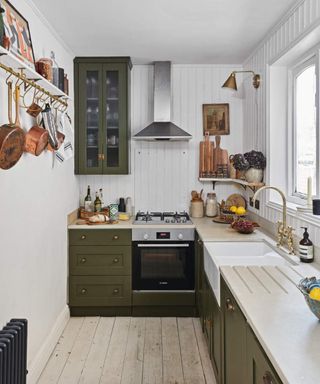 A modern traditional kitchen with beige countertop worktop and olive green cabinery in Jessica Taylor's small townhouse