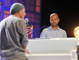 Pep Guardiola performs a song with Catalan singer-songwriter Lluis Llach at a charity concert in 2012.