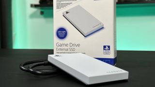 The Seagate Game Drive External SSD on a black table top with its box and cable