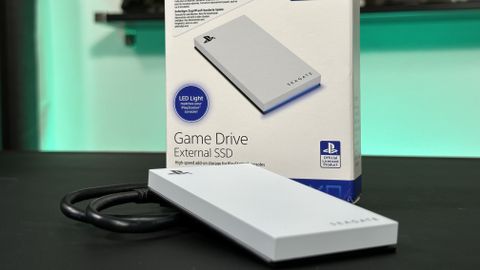 The Seagate Game Drive External SSD on a black table top with its box and cable